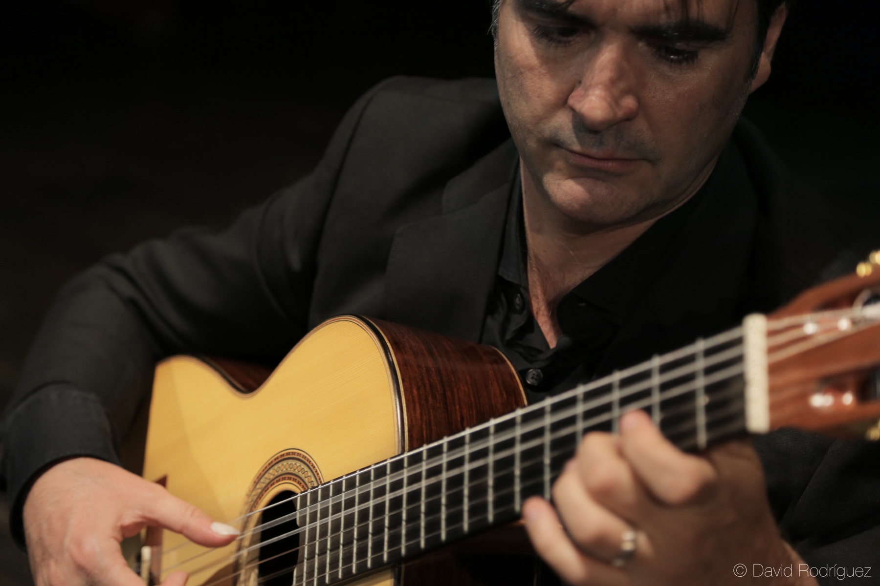 Close portrait of Rafael Serrallet performing classical guitar